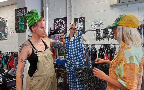 A woman holding a blue dress.