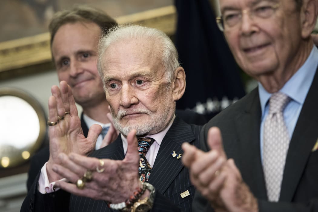 Buzz Aldrin, former NASA Astronaut and second man on the moon, gives a thumbs up as US President Donald Trump speaks about an executive order to reinstate the National Space Council at the White House June 30, 2017 in Washington, DC.