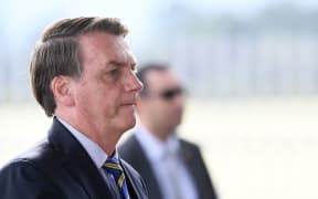 Brazilian President Jair Bolsonaro gestures as he speaks to supporters while leaving Alvorada Palace in Brasilia, on 6 May 2020.