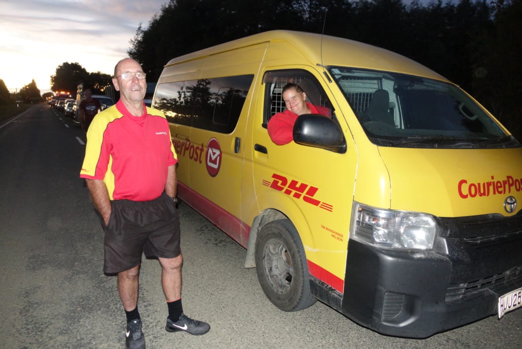 CourierPost driver Debbie Boyd (in van) and contractor Lloyd Granger wait in the queue for Takaka.