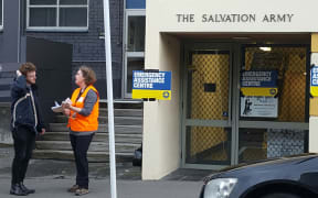 Central Wellington resident Toby Jones talks to a Civil Defence official outside the evacuation centre.