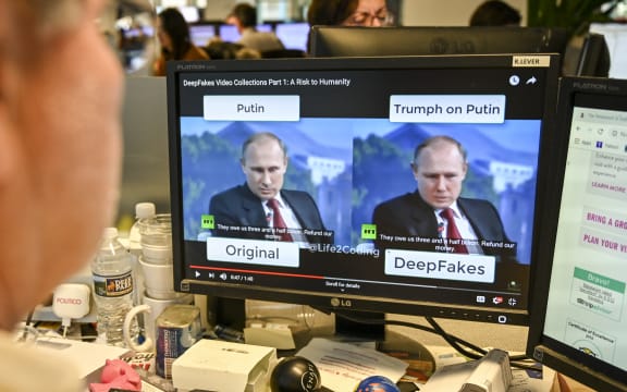 An AFP journalist views a video on 25 January, 2019, manipulated with artificial intelligence to potentially deceive viewers, or "deepfake" at his newsdesk in Washington, DC.