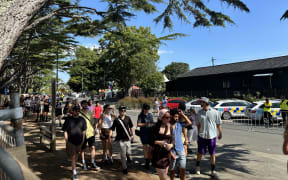 Concertgoers wait in a queue at today's Laneway Festival in Auckland.