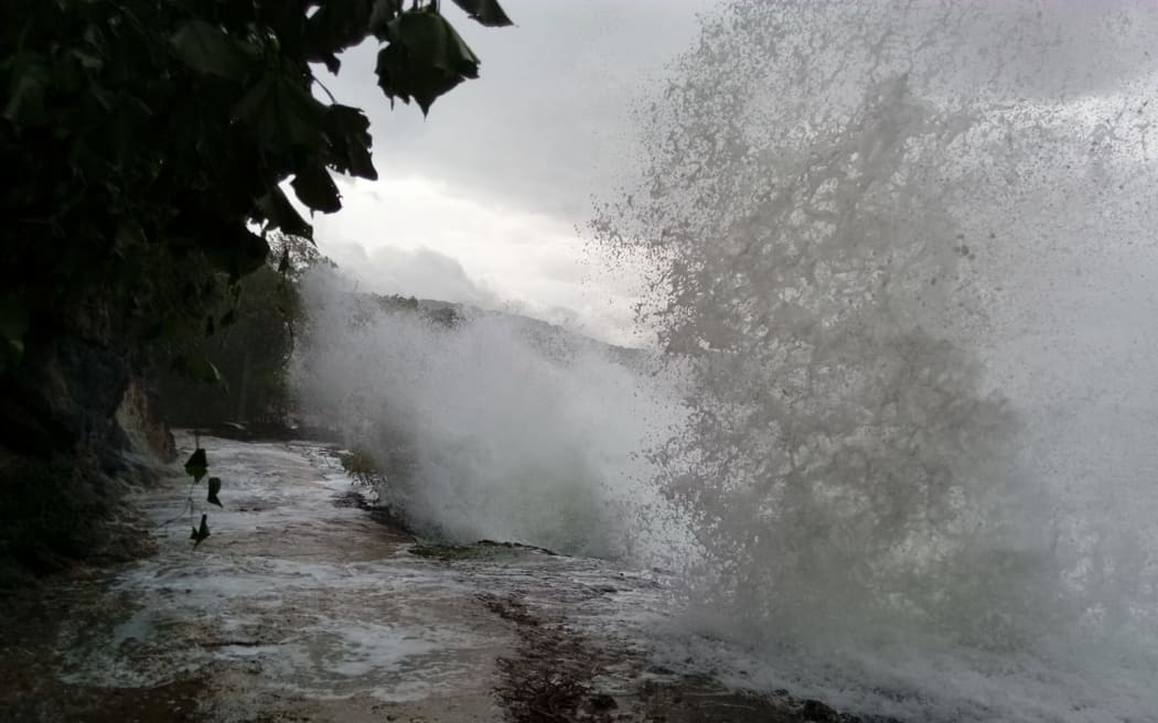 Heavy seas hit a road on Pentecost during Cyclone Hola.
