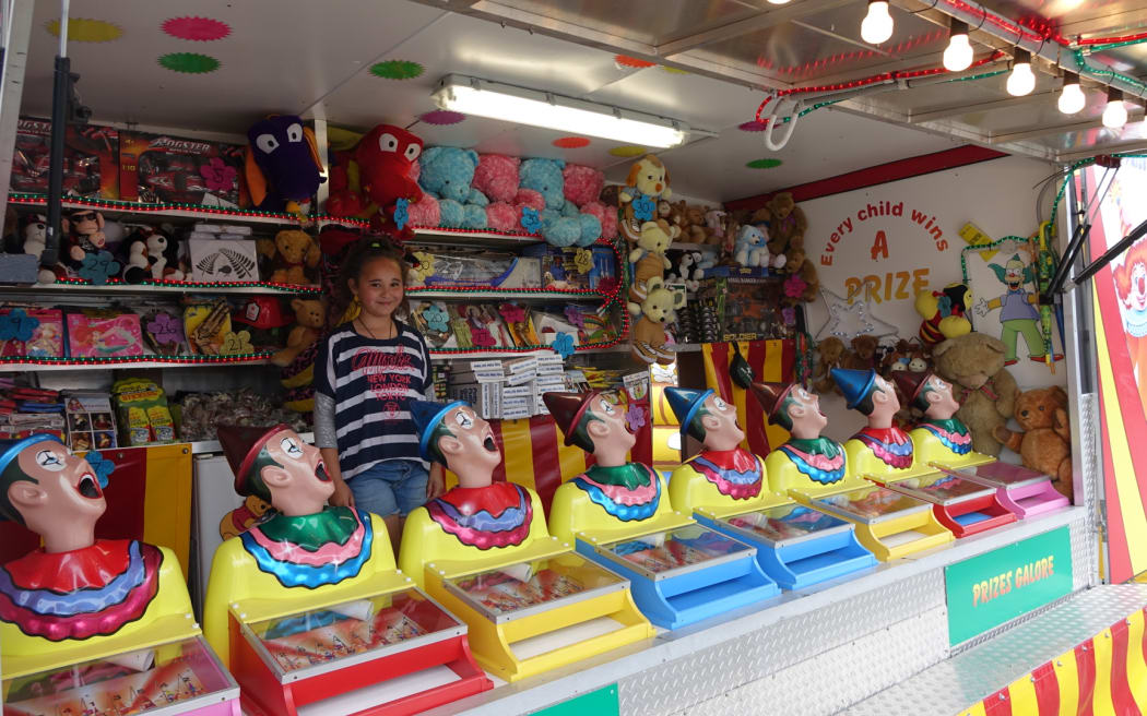 Georgia Avery helps out her dad, Jason, at his concession stand at the Canterbury A& P show.