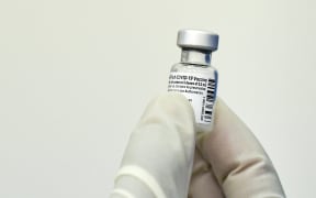A nurse holds a vial of the Pfizer-BioNTech vaccine against Covid-19.