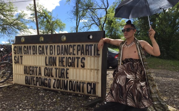 Mika in front of the sign at GayBiGayBi, Austin, 2015