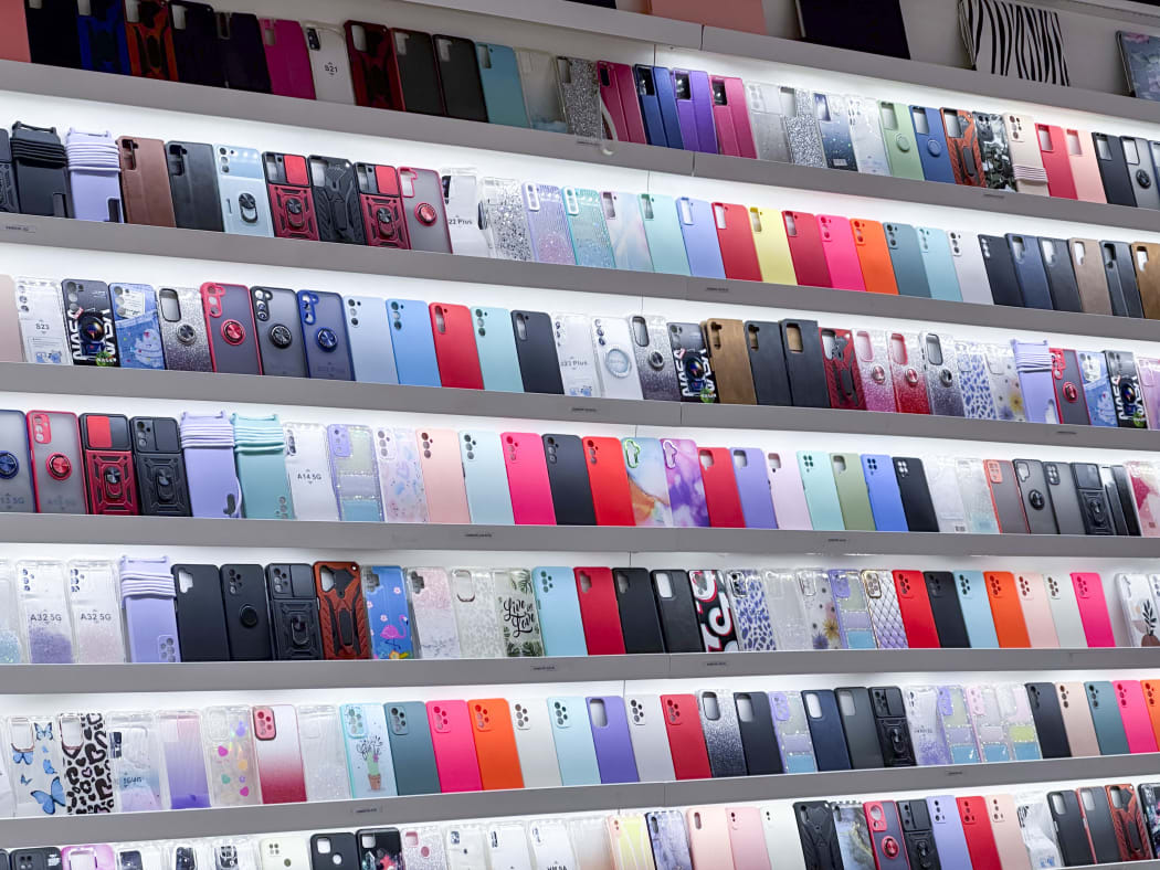 Store featuring cases for phones (Photo by Philippe TURPIN / Photononstop / Photononstop via AFP)