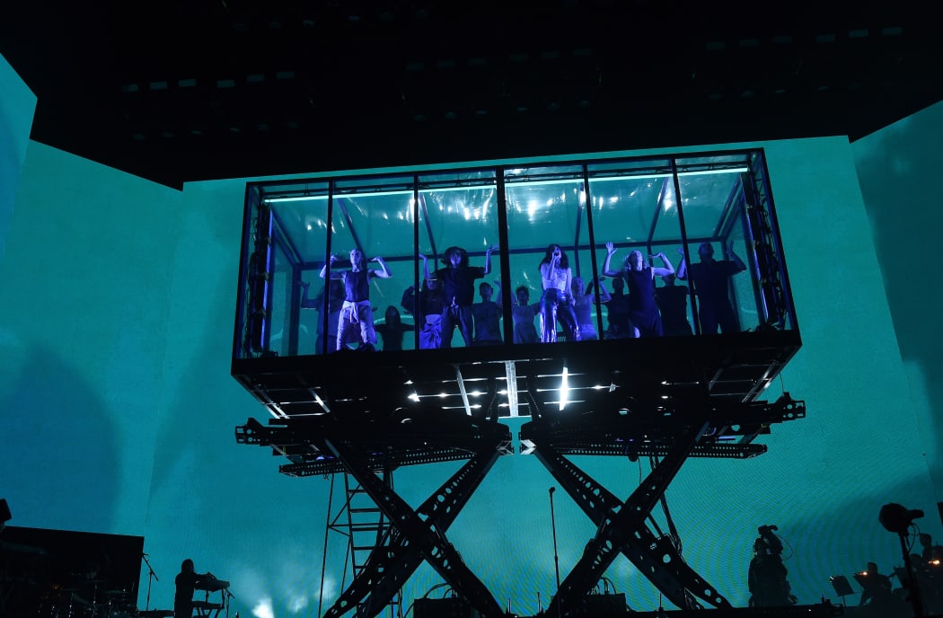 On a set designed by Es Devlin, dancers re-enacted party scenes in a translucent box suspended above the stage.