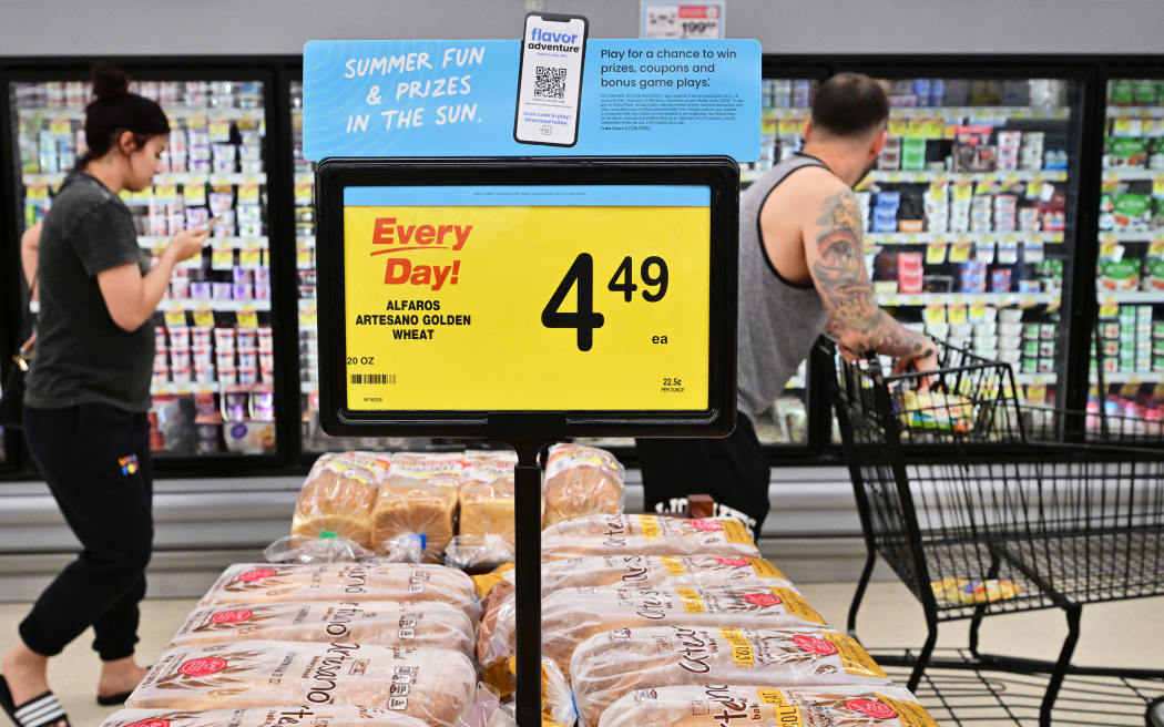 People shop at a grocery supermarket in Alhambra, California, on 13 July, 2022.
