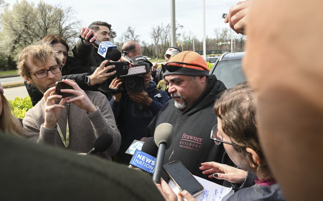 Jesus Campos, a worker originally from El Salvador, speaks about his coworkers who were working on the night shift while repairing the Francis Scott Key Bridge at the time of the accident when it collapsed after a Singapore-flagged container ship called the Dali collided with it along a shipping channel in Baltimore, Maryland, on March 26, 2024. The bridge collapsed early March 26 after being struck by the Singapore-flagged Dali container ship, sending multiple vehicles and people plunging into the frigid harbor below. There was no immediate confirmation of the cause of the disaster, but Baltimore's Police Commissioner Richard Worley said there was "no indication" of terrorism. (Photo by ROBERTO SCHMIDT / AFP)