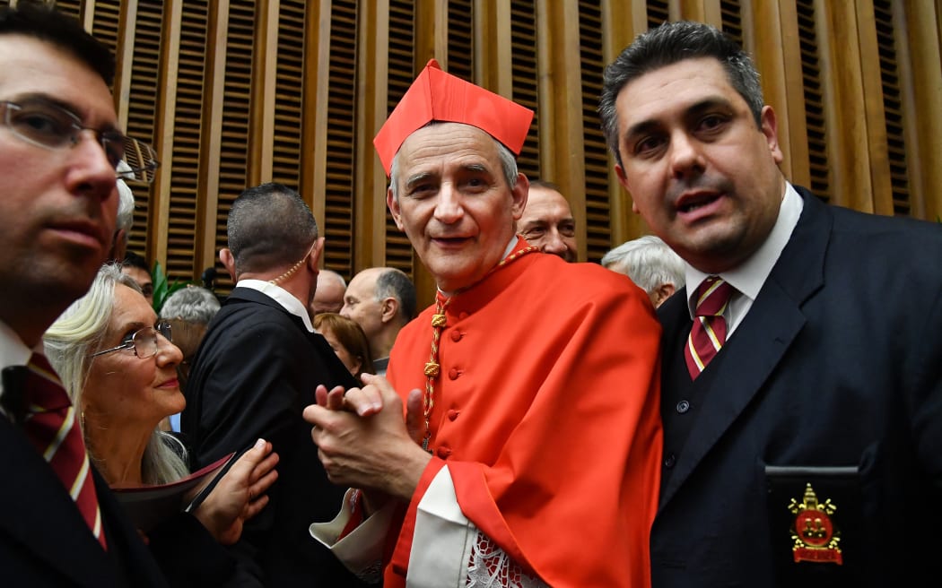 New Cardinal, Italian prelate Matteo Maria Zuppi (C) looks on as he meets with relatives and friends during a courtesy visit following his appointment by the Pope, during an Ordinary Public Consistory for the creation of new cardinals on October 5, 2019 in the Vatican. Pope Francis appoints 13 new cardinals at the 2019 Ordinary Public Consistory, choosing prelates whose lifelong careers reflect their commitment to serve the marginalized and local church communities, hailing from 11 different nations and representing multiple religious orders. (Photo by Tiziana FABI / AFP)