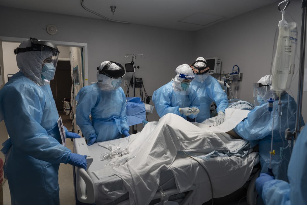 Medical staff members treat a patient suffering from Covid-19 in an intensive care unit at the United Memorial Medical Center on October 31, 2020 in Houston, Texas.