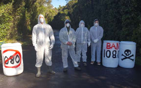Members of 100% Pure Taranaki picket the toad into the North Egmont Visitors Centre.