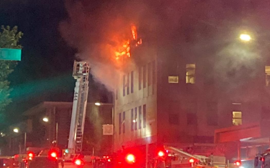 Flames seen in the top storey of the Loafers Lodge building in Adelaide Road, Newtown, Wellington.