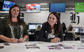 PM Jacinda Ardern propping a special suffrage edition of the New Zealand Herald with editor Miriyana Alexander.