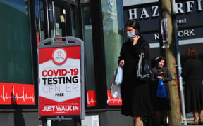 A person walks past a Covid-19 Testing Center in the Borough Park section of Brooklyn, one of the five boroughs of New York City on 9 October 2020.