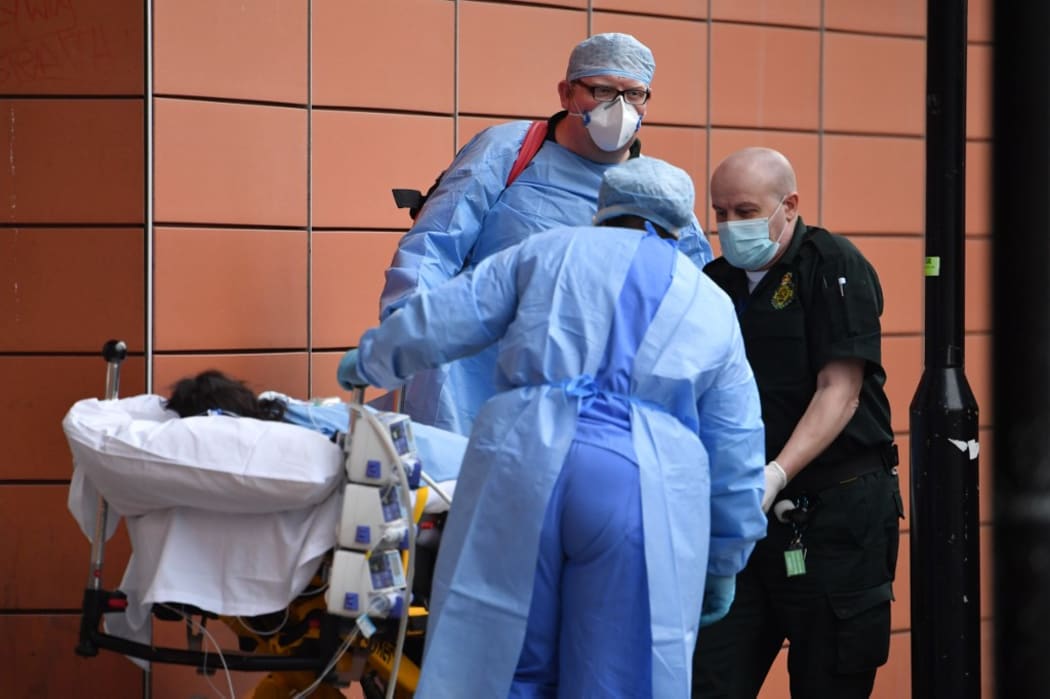 Paramedics unload a patient from an ambulance outside the Royal London Hospital in east London on January 8, 2021.