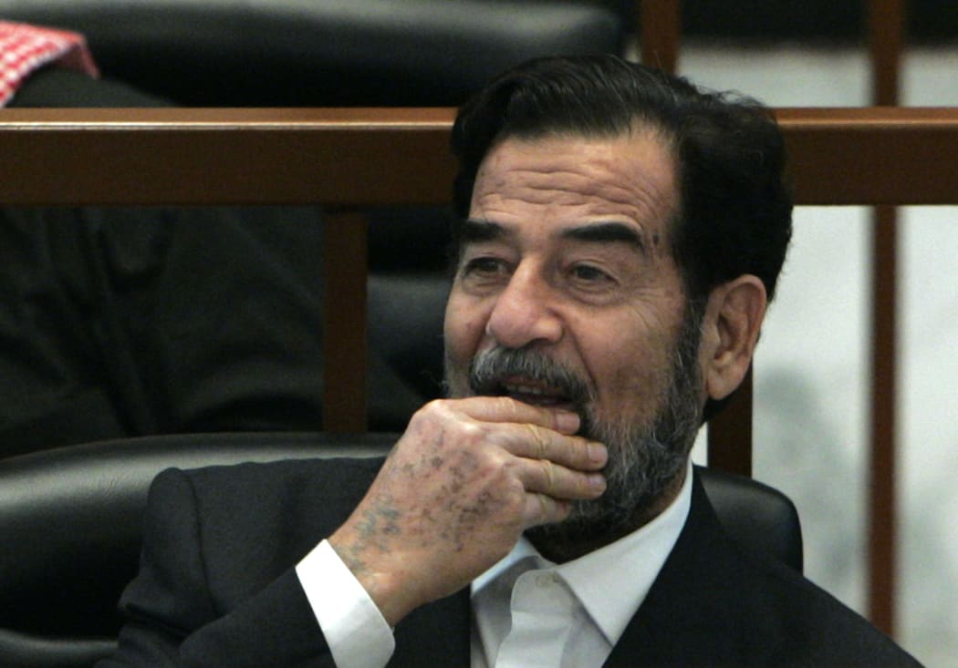 Saddam Hussein listens to evidence during his trial in Baghdad, 2006.