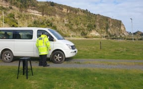 A Māori warden gives parking advice at the Mōkau pop-up clinic.
