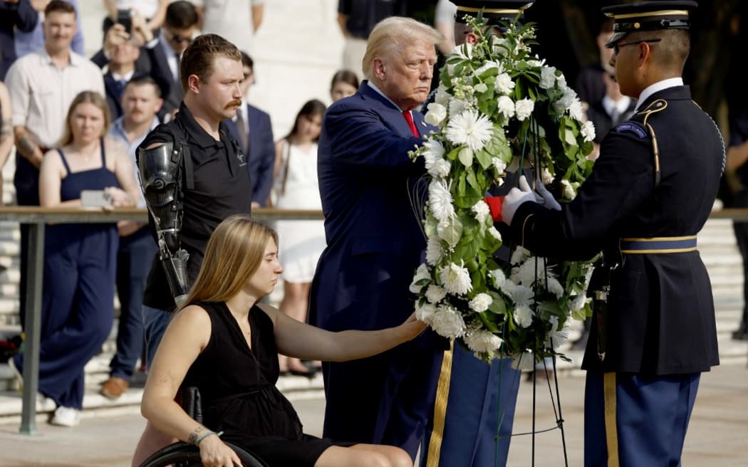 ARLINGTON, VIRGINIA - AUGUST 26: Republican presidential nominee, former U.S. President Donald Trump lays a wreath alongside Marine Cpl. Kelsee Lainhart (Ret.) and and U.S. Marine Corps. Sergeant Tyler Vargas-Andrews (Ret.) who were injured at the Abbey Gate Bombing, during a wreath-laying ceremony at the Tomb of the Unknown Soldier at Arlington National Cemetery on August 26, 2024 in Arlington, Virginia. Monday marks three years since the August 26, 2021, suicide bombing at Hamid Karzai International Airport, which killed 13 American service members.   Anna Moneymaker/Getty Images/AFP (Photo by Anna Moneymaker / GETTY IMAGES NORTH AMERICA / Getty Images via AFP)