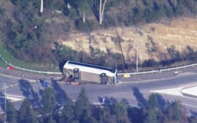 This frame grab taken from video footage provided by the Australian Broadcast Corporation (ABC) on 12 June, 2023 via AFPTV shows the site of a bus crash, where 10 people from a wedding party were killed, in Cessnock, in Australia's Hunter wine region north of Sydney.