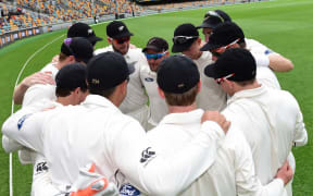 The Black Caps huddle before play