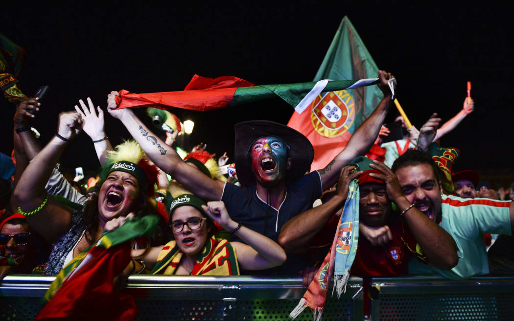Portugal supporters celebrate their team's victory at Terreiro do Paco square, Lisbon, after watching the final on a giant screen.