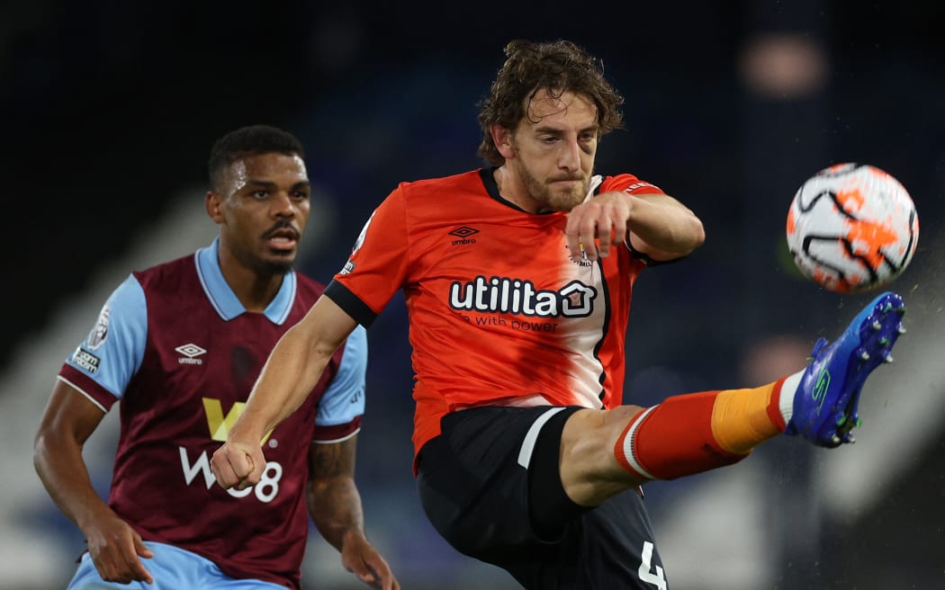 Luton Town's Welsh defender Tom Lockyer (right) clears the ball during the English Premier League football match between Luton Town and Burnley at Kenilworth Road in Luton, north of London on 3 October, 2023.