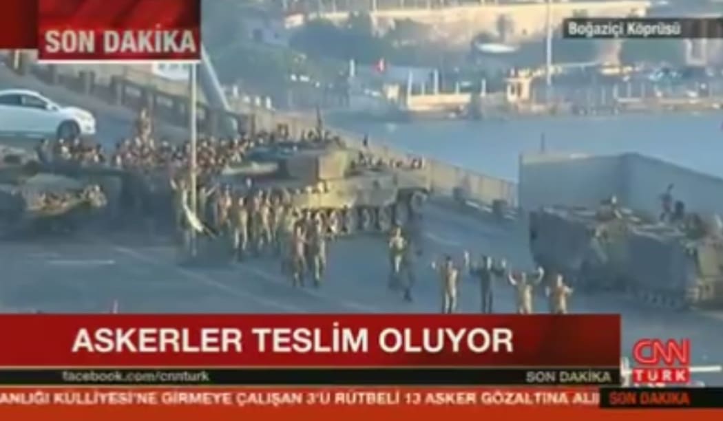 Dramatic images showed dozens of soldiers walking away from their tanks with their hands up on one of Istanbul's Bosphorus bridges.