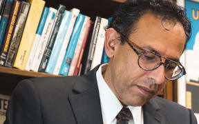 Author Mahyar Amouzegar signs books.