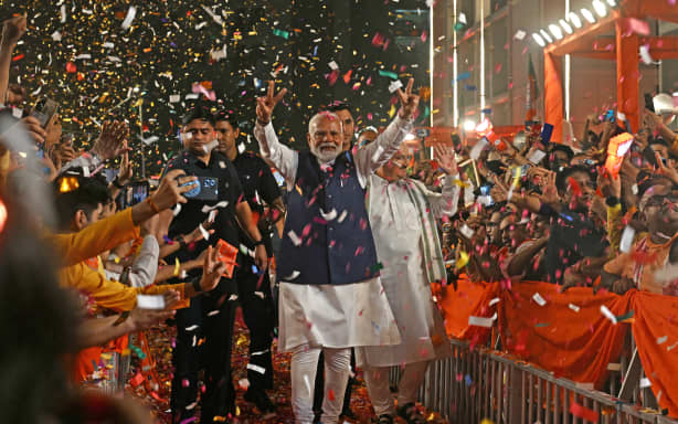 Indian Prime Minister Narendra Modi (center) displays a victory sign as he arrives at the Bharatiya Janata Party (BJP) headquarters to celebrate the party's victory in the country's general election, in New Delhi, June 4, 2024. Modi claimed election victory for his party and its allies on June 4, but the opposition said it had 