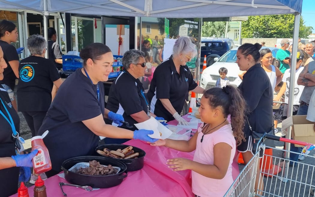 Volunteers hand out food in Wairoa, following Cyclone Gabrielle.