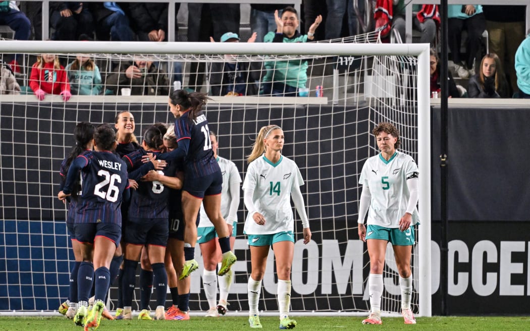 Katie Bowen (14) and Meikayla Moore of New Zealand are dejected after conceding a goal against the United States.