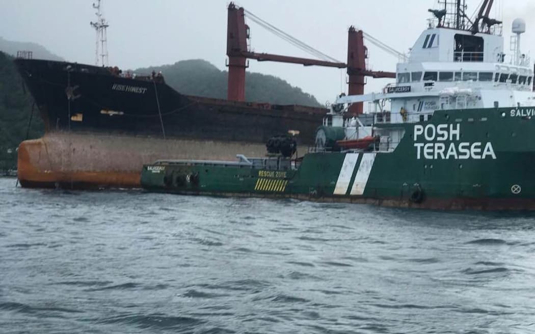 The Wise Honest is towed out to the middle of Pago Pago Harbour