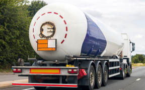 A fuel tanker traveling along a motorway in the United Kingdom