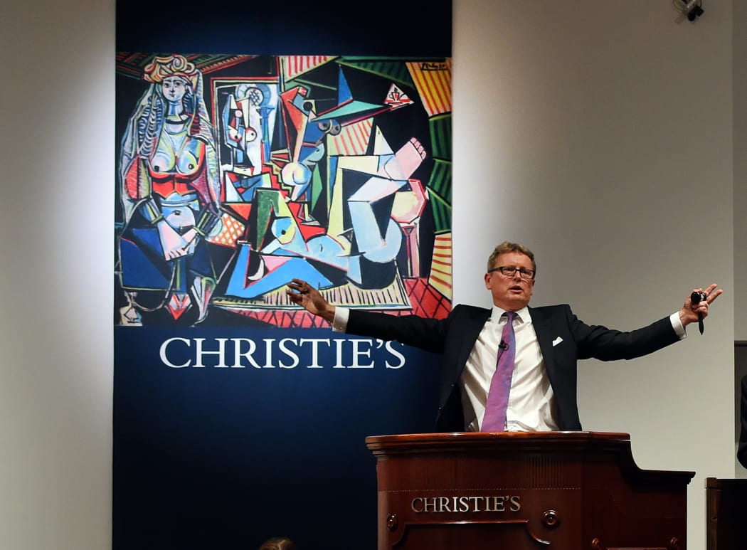 Jussi Pylkkanen, president of Christie's, takes bids in New York art work, "Les femmes d'Alger" by Pablo Picasso.