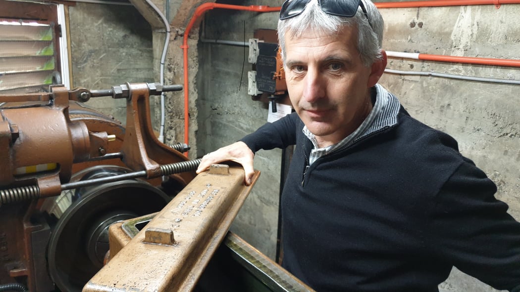 Peter Tantrum stands inside the engine room of the elevator.