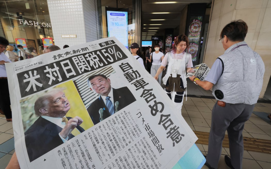An extra edition of Japanese daily newspaper is published reporting that the United States of America and Japan had agreed on a 15% tariff in Osaka City, Osaka Prefecture on July 23, 2025. U.S. President Donald Trump announced on his social media that an agreement had been reached on reciprocal tariffs on Japan at 15% in negotiations regarding tariff measures.    ( The Yomiuri Shimbun ) (Photo by Takumi Harada / The Yomiuri Shimbun via AFP)