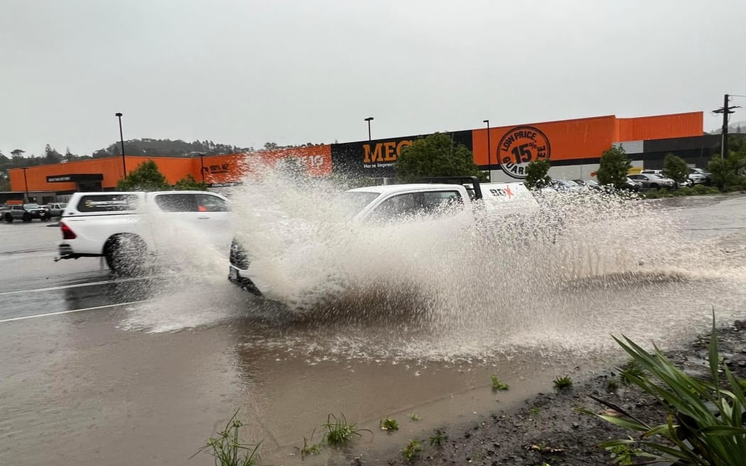 A car driving through floodwaters in Whangārei on 9 May 2023.