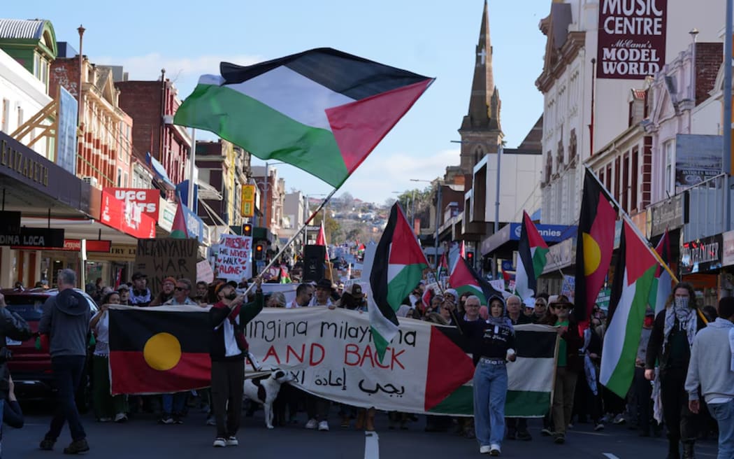 Thousands of people march through the streets of Hobart.