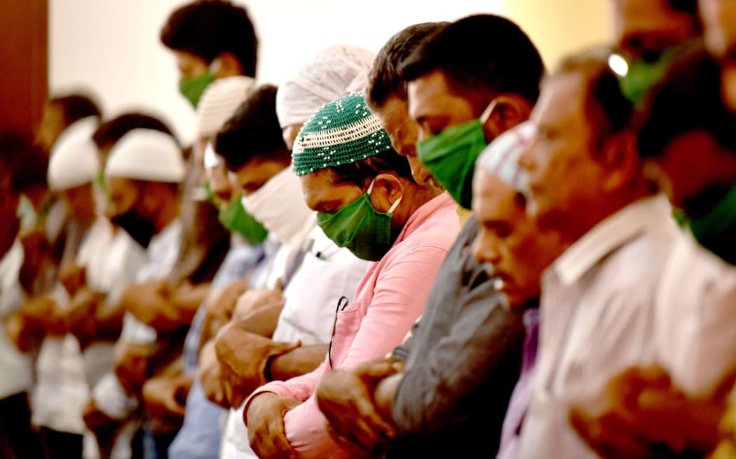 Muslims devotees wear masks to protect themselves from the spread of COVID-19 novel coronavirus as they are offer Friday prayer at Palayam Juma Mosque in Thiruvananthapuram on March 20, 2020.