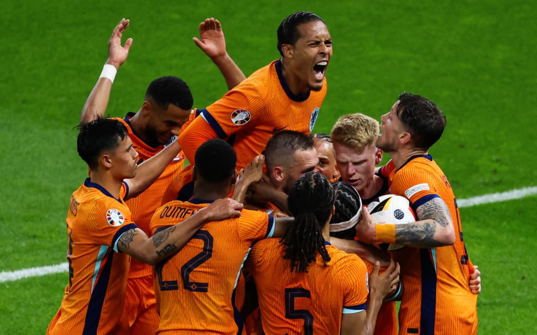 Netherlands' players celebrate their team's first goal during the UEFA Euro 2024 quarter-final football match between the Netherlands and Turkey.