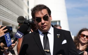 WEST ISLIP, NEW YORK - AUGUST 19: Former U.S. Rep. George Santos gives a statement after a court hearing on August 19, 2024 in West Islip, New York. Santos pleaded guilty to wire fraud and aggravated identity theft weeks before his federal trial was set to begin. His sentencing has been scheduled for February 7, and he faces more than six years in prison under federal sentencing guidelines. Santos owes at least $370,000 in restitution. He was expelled from Congress in 2023, becoming the sixth member in the chamber’s history to be ousted by colleagues.   Michael M. Santiago/Getty Images/AFP (Photo by Michael M. Santiago / GETTY IMAGES NORTH AMERICA / Getty Images via AFP)