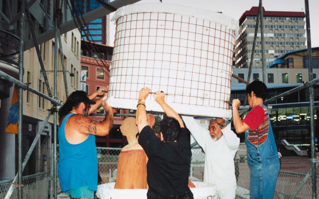 Wi Taepa, Colleen Waata Urlich, Paerau Corneal and Manos Nathan unload ceramic artworks from the gas-fired kiln at Civic Square during Uku! Uku! Uku! at the Wellington Arts Festival.