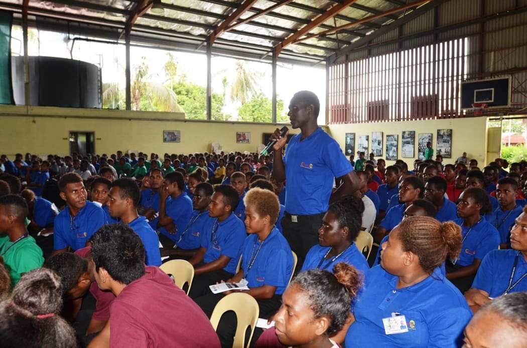 A student at Don Bosco Technical Institute asks a question during the  RAMSI drawdown briefing.