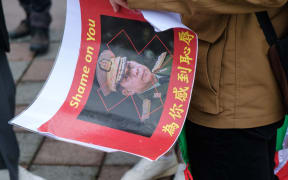A person seen holding the portrait of Min Aung Hlaing in front of the American Institute in Taiwan (AIT) to pressure the US for more sanctions against the military regime in Myanmar on 7 March 2021.