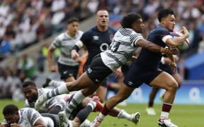 Fiji's Lekima Tagitagivalu tackles England's Marcus Smith during the World Cup warm-up match between England and Fiji at Twickenham Stadium on 26 August.