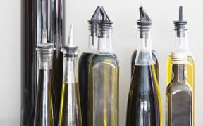 Assorted cooking oil bottles in a restaurant (Photo by Fabrice Lerouge / Onoky / Photononstop via AFP)