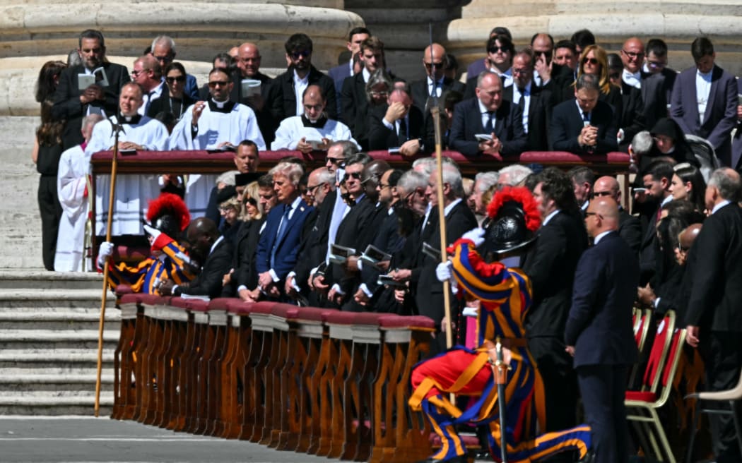 France's President Emmanuel Macron (C-L) and US President Donald Trump (C-R) stand during the funeral ceremony of late Pope Francis at St Peter's Square in The Vatican, on April 26, 2025. (Photo by Andreas SOLARO / AFP)